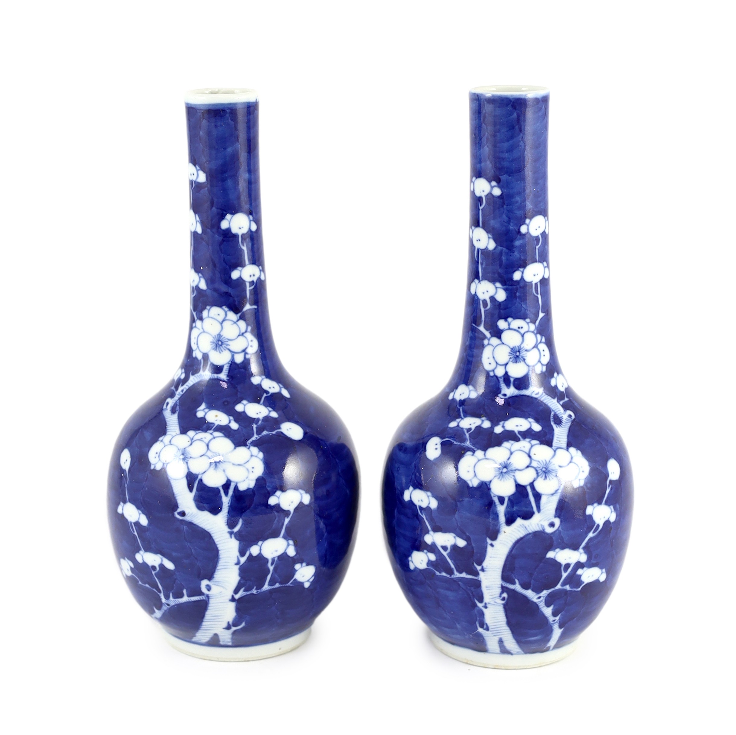 A pair of Chinese blue and white prunus bottle vases, early 20th century, 26cm